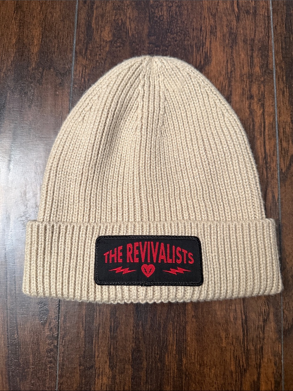 The Revivalists Beanie Hat in Beige with Red Patch